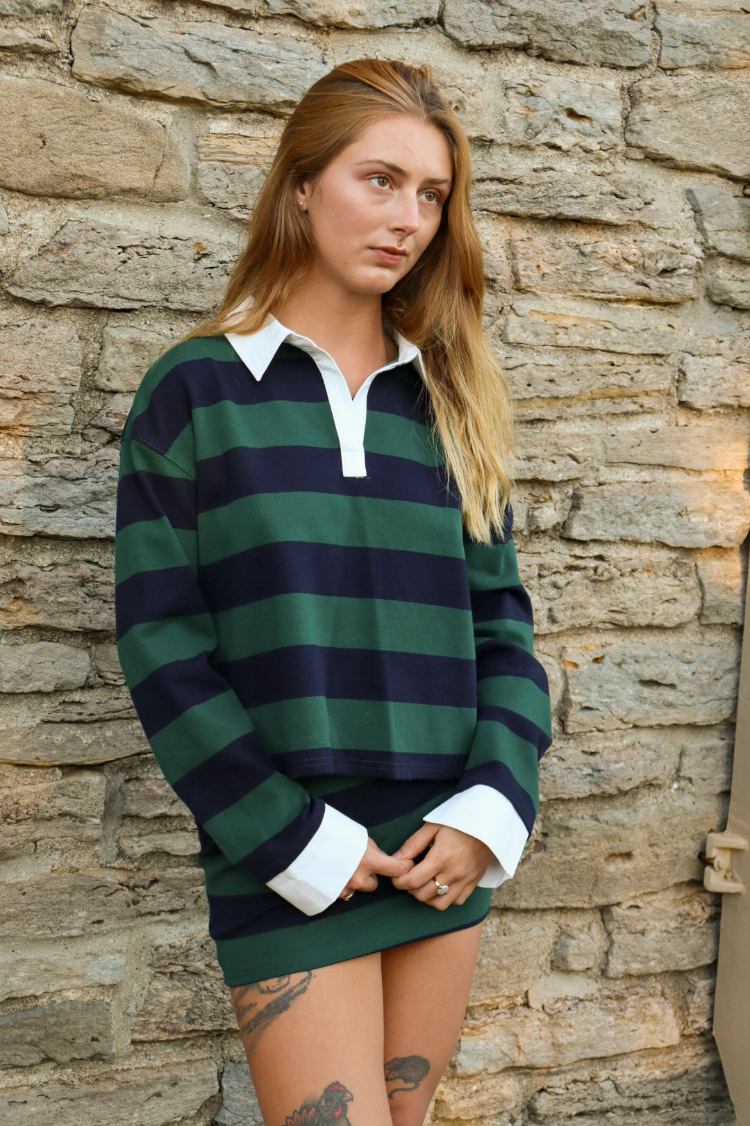 Striped Collar Polo Set against the stone wall