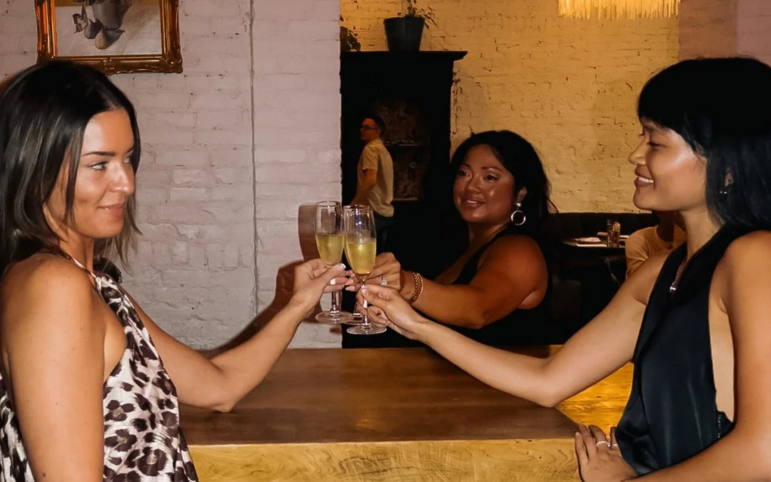Girl dinner cheers in The Founding Edit